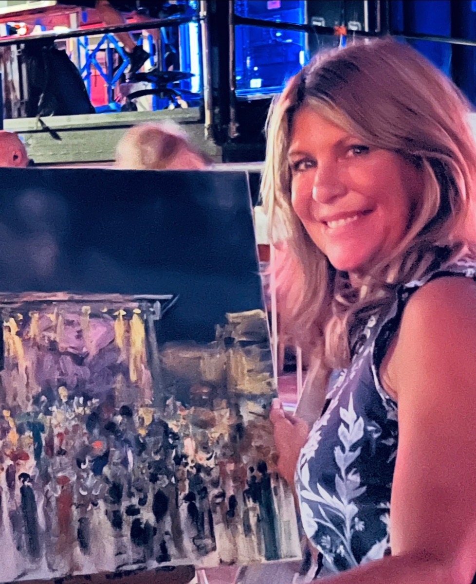 Founder Shannon Harris with a painting created live at a concert